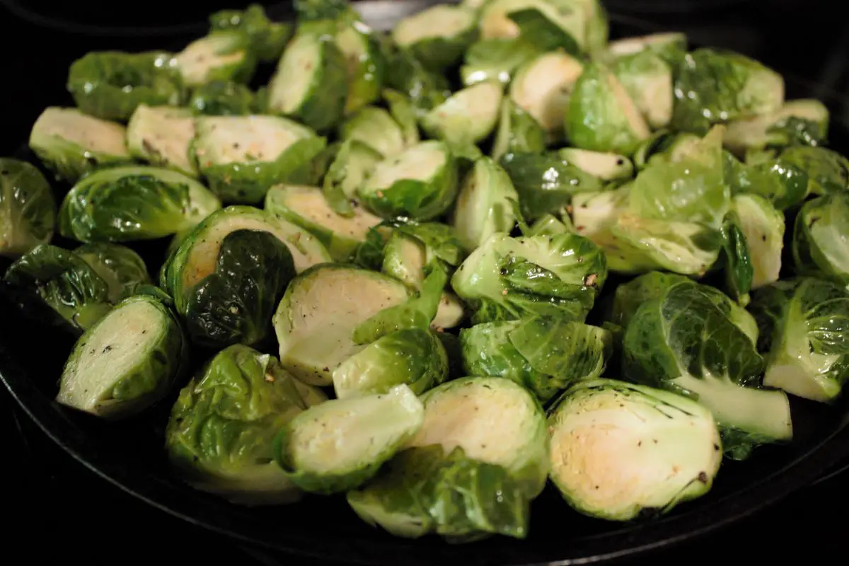 Brussel Sprouts cut in half length wise and seasoned with Extra virgin olive oil, salt, and pepper.