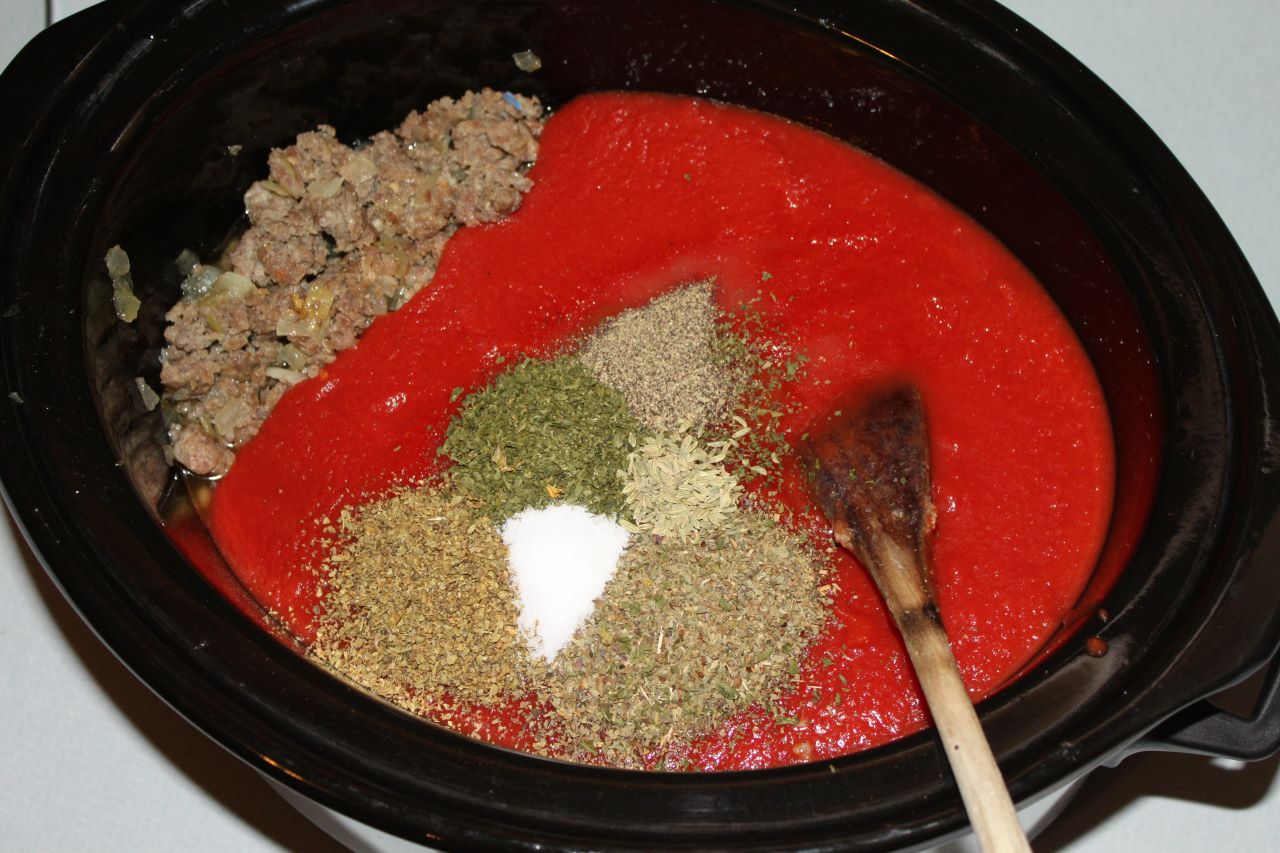 Pasta sauce with seasonings sprinkled over the sauce.