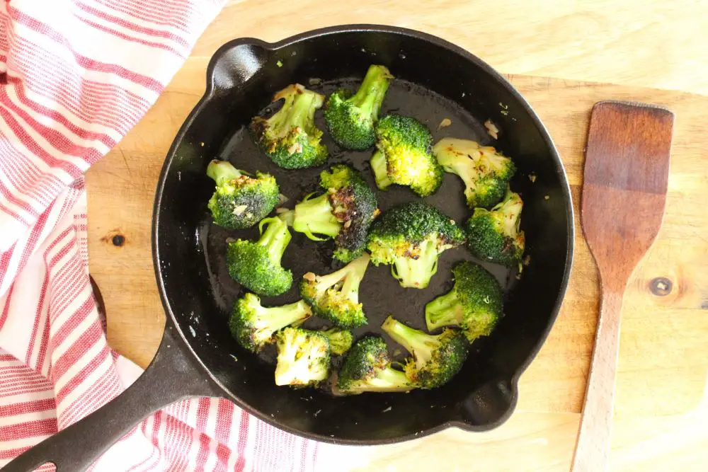 Sauteed broccoli in a cast iron skillet.