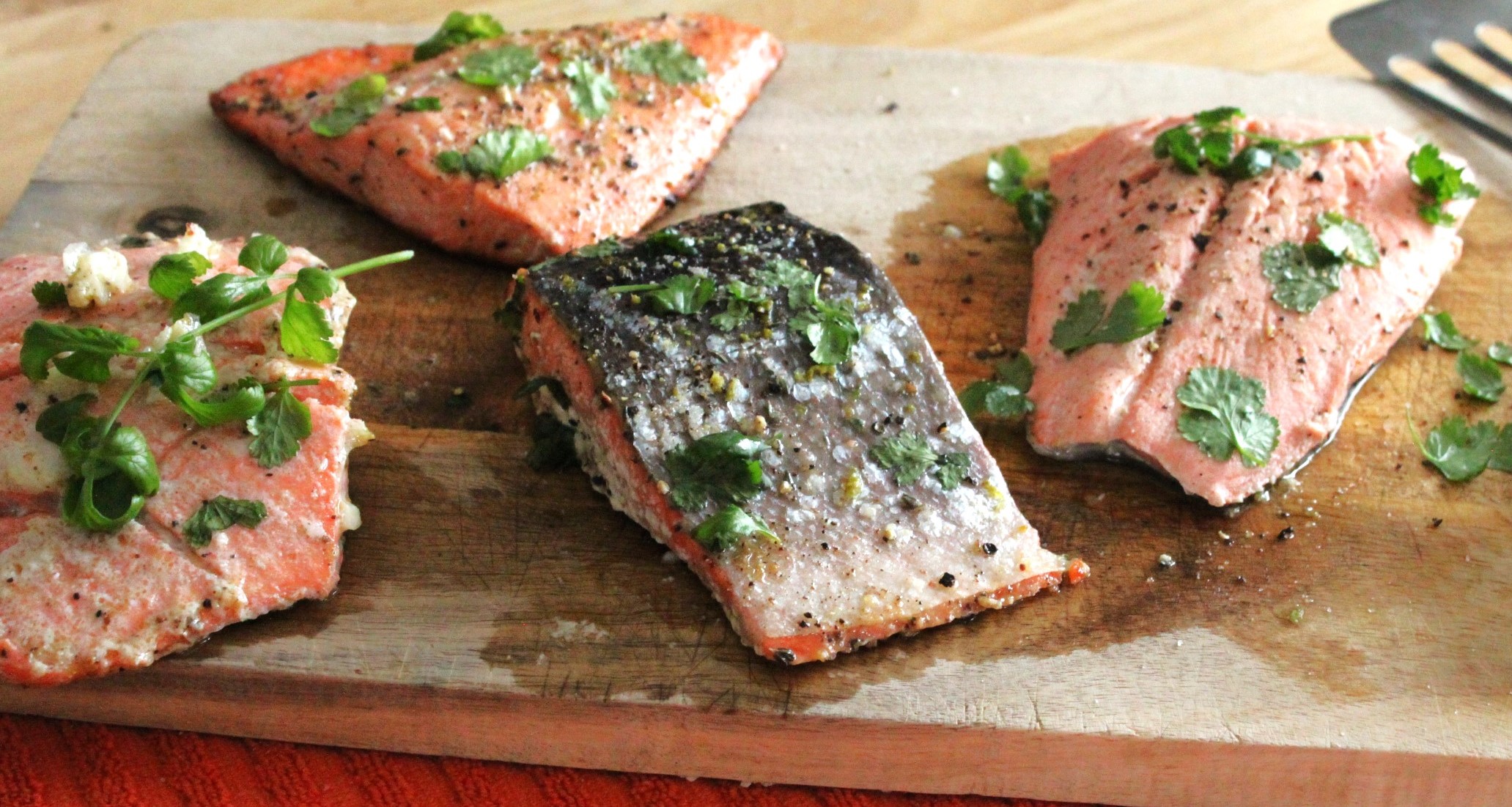 Cooked Salmon in 5 different methods on a cutting board.